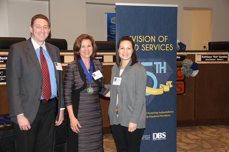 Cathy Matthews accepts Successful 75 Award from DBS administrators Jeff Whitehead and Mireya Hernandez